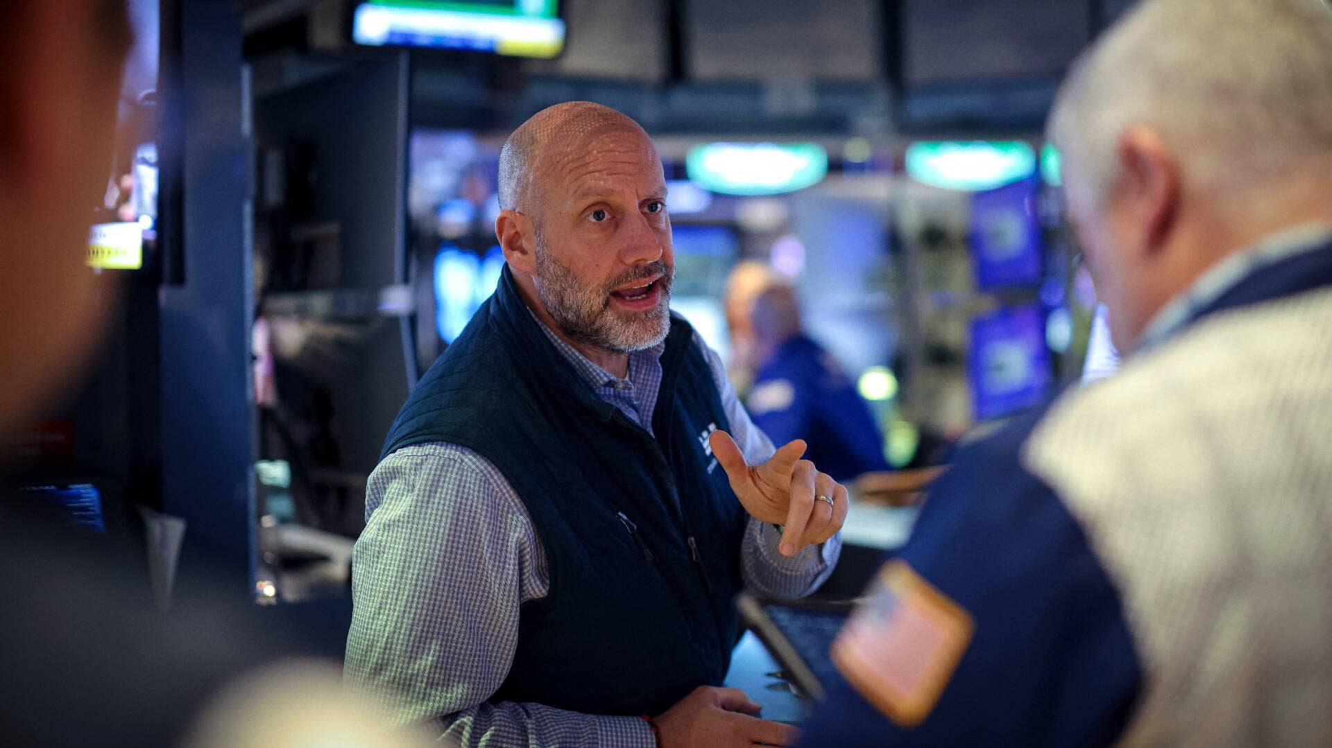 A NYSE trader near a post on the stock exchange floor.