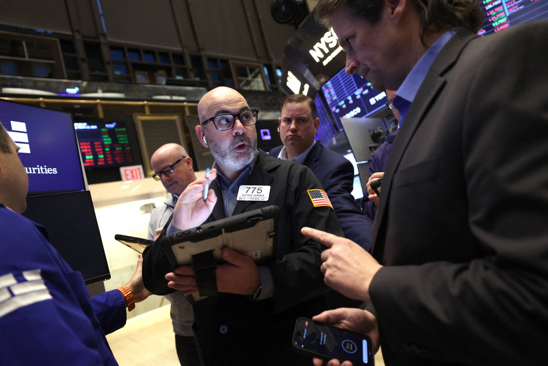 Traders work on the NYSE floor at the opening bell in New York, March 2026
