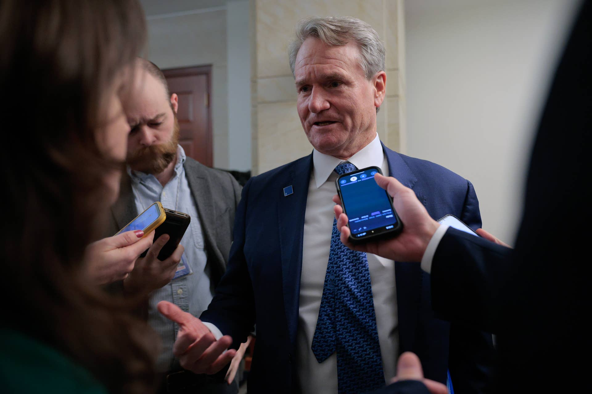 Bank of America Chairman and CEO Brian Moynihan speaks with reporters after meeting Senate Banking Committee members at the U.S. Capitol Visitors Center on December 11, 2025, in Washington