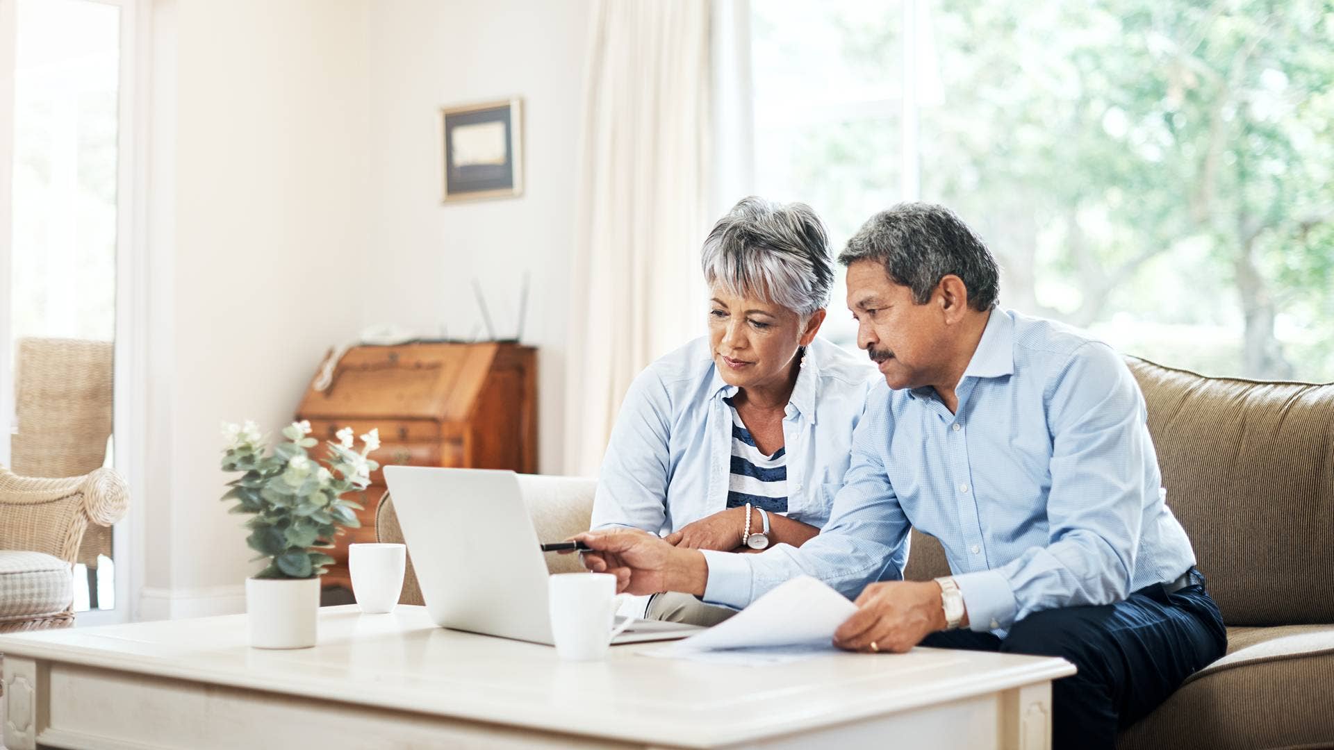Couple checking information on a laptop together