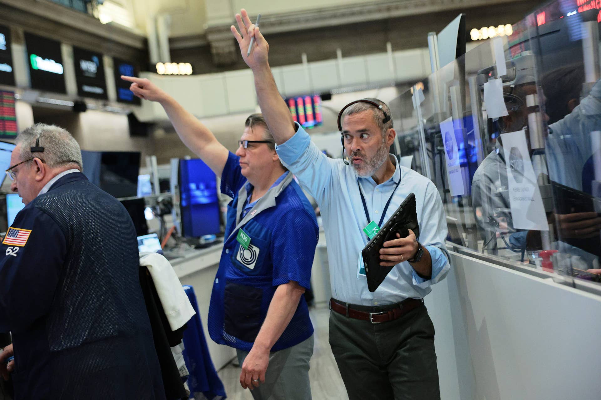 Traders work on the floor of the New York Stock Exchange during morning trading