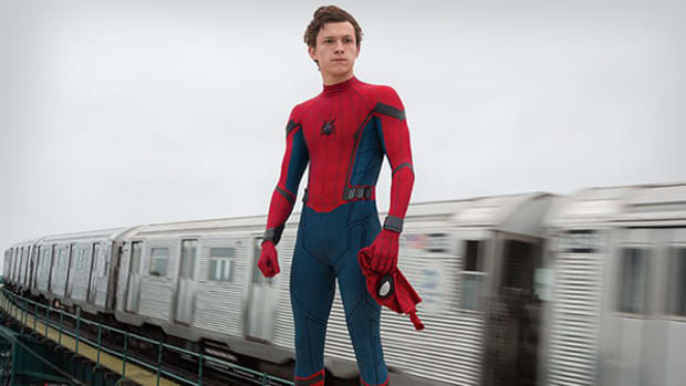 Spider-Man stands on a train.