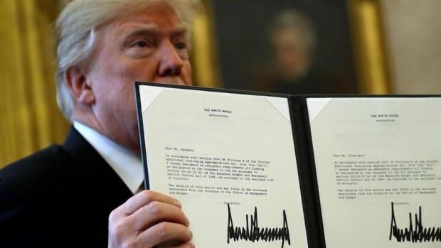 Midday Market: Stocks Trade Lower as President Trump Inks Tax Bill Into Law