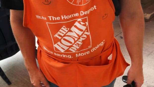 A worker wears a Home Depot apron.
