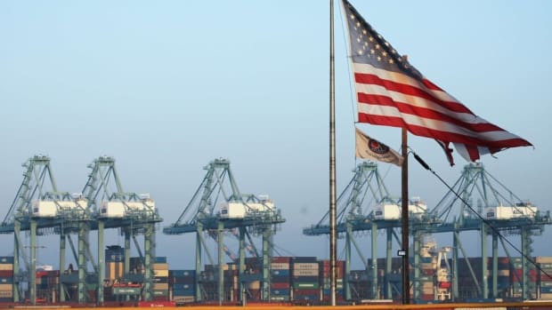 An American flag flies with shipping containers stacked at the Port of Los Angeles in November 2019 in San Pedro, California. Photo AFP