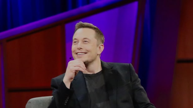 Elon Musk smiling onstage at TED 2017.