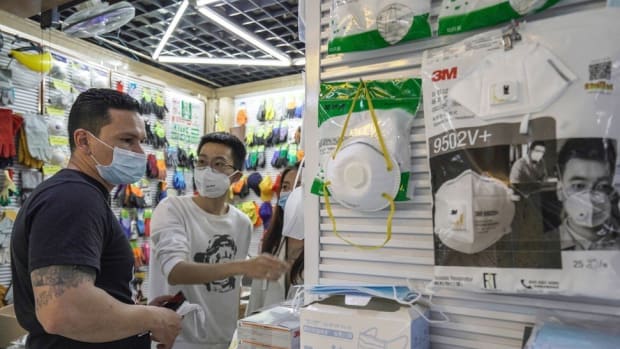 A foreign buyer visits a stall selling face masks. Photo: Thomas Yau