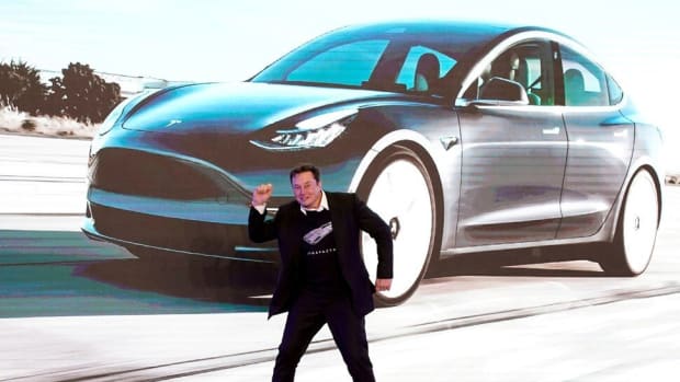 Elon Musk dances onstage during a delivery event for Tesla's China-made Model 3 cars in Shanghai on January 7, 2020.