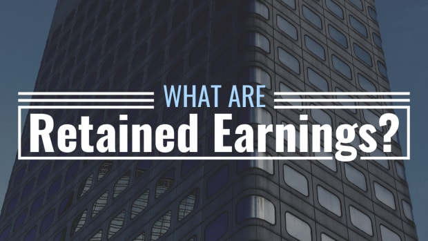Darkened photo of a tall office building with text overlay that reads "What Are Retained Earnings?"Kasia Kiesler