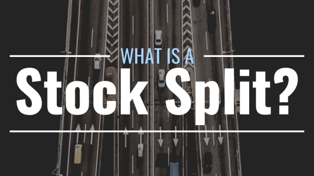 Darkened arial photo of a highway splitting into multiple sections with text overlay that reads "What Is a Stock Split?"