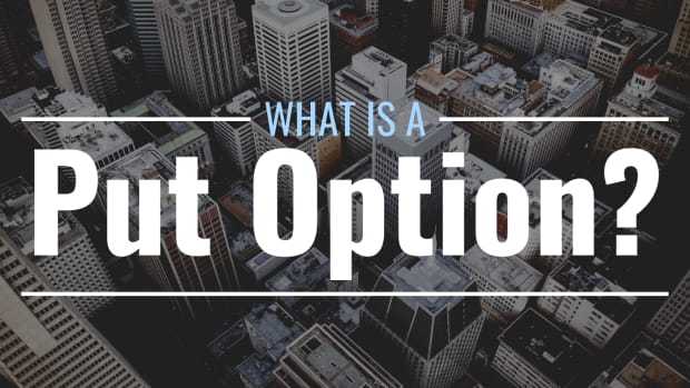 Darkened, bird's-eye-view photo of a city's buildings with text overlay that reads "What Is a Put option?"