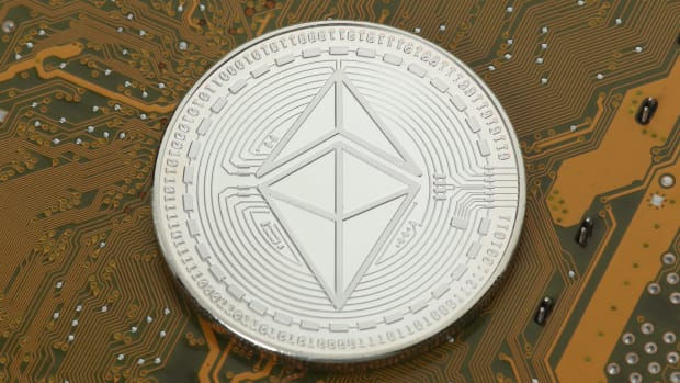 Ethereum coin on circuit board.