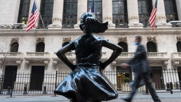 People walk past the New York Stock Exchange on Wall Street. The benchmark S&P 500 Index rose to an all-time high on Wednesday. Photo: AFP