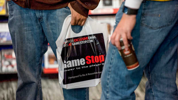 A customer holds a GameStop Corp. shopping bag inside a store in San Francisco, California, U.S., on Tuesday March 24, 2015. GameStop Corp. is scheduled to release earnings figures on March 26. Photographer: David Paul Morris/Bloomberg via Getty Images