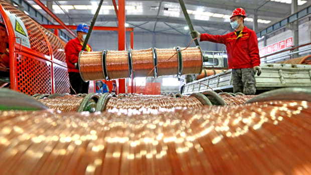 URUMQI, CHINA - NOVEMBER 15: Workers transfer copper wires at Xinjiang Euphratica Cable Manufacturing Co., Ltd on November 15, 2021 in Urumqi, Xinjiang Uygur Autonomous Region of China. (Photo by Cai Zengle/VCG via Getty Images)