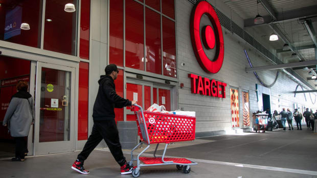 A shopper leaves a Target store. lead.