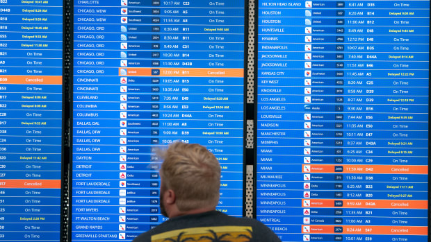 WASHINGTON, DC - JULY 19: A traveler checks flight information at Ronald Regan Washington National Airport on July 19, 2024 in Washington, DC. A global computer outage started from an update from the cybersecurity company CrowdStrike that impacted flights worldwide along with disrupting broadcasters and banking services. (Photo by Nathan Howard/Getty Images)