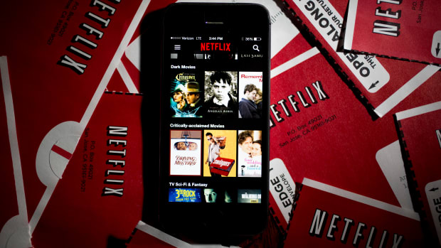 The Netflix Inc. application (app) is displayed on an Apple Inc. iPhone 5s surrounded by DVD mailers in this arranged photograph in Washington, D.C., U.S., on Tuesday, April 14, 2015. Netflix Inc., the largest online subscription video service, is expected to release earnings figures on April 15. Photographer: Andrew Harrer/Bloomberg via Getty Images