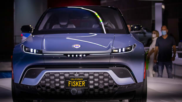 Car enthusiasts view the new Fisker Ocean all electric vehicle at the LA Auto Show opening day at Los Angeles Convention Center in Los Angeles on Nov. 19, 2021. (Allen J. Schaben / Los Angeles Times via Getty Images)