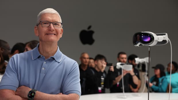 CUPERTINO, CALIFORNIA - JUNE 05: Apple CEO Tim Cook stands next to the new Apple Vision Pro headset is displayed during the Apple Worldwide Developers Conference on June 05, 2023 in Cupertino, California. Apple CEO Tim Cook kicked off the annual WWDC23 developer conference with the announcement of the new Apple Vision Pro mixed reality headset. (Photo by Justin Sullivan/Getty Images)