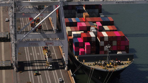 OAKLAND, CALIFORNIA - APRIL 28: In an aerial view, a shipping container is lifted off a container ship docked at the Port of Oakland on April 28, 2025 in Oakland, California. American importers are seeing a surge in canceled sailings by freight ships out of China as the Trump administration's tariffs continue to impact the world's economy. (Photo by Justin Sullivan/Getty Images)