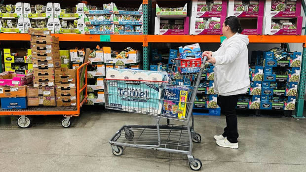 A woman shops for items at a Costco store. lead.