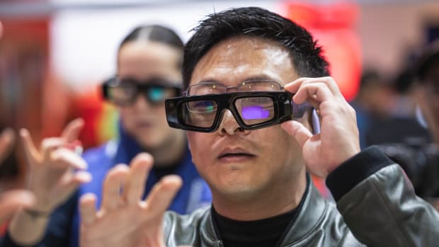 BARCELONA, SPAIN - MARCH 6: People try out Qualcomm AI Smart Glasses at Mobile World Congress 2025 on March 6, 2025 in Barcelona, Spain. Mobile World Congress 2025 has seen its best attendance figures since the pandemic, with around 109,000 attendees. Artificial Intelligence was the most important topic during the congress, with 2,900 exhibiting companies, in addition to new developments and technological innovations. (Photo by Cesc Maymo/Getty Images)