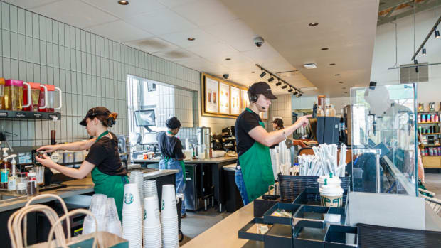 Starbucks baristas at work making drinks. lead.