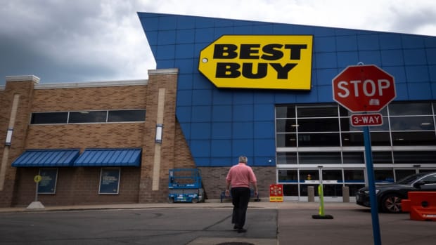 A person walks outside a Best Buy store. lead.