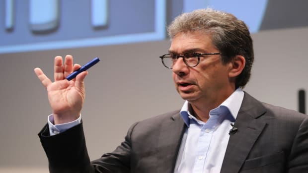 Andre Calantzopoulos of Philip Morris International displays the smoke-free cigarette "IQOS 3." lead.
