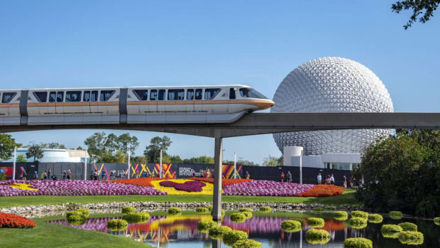 The monorail at Disney World travels in front of the iconic dome at Epcot. lead.