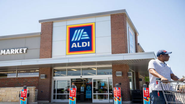 A customer walks out of an Aldi supermarket. lead.