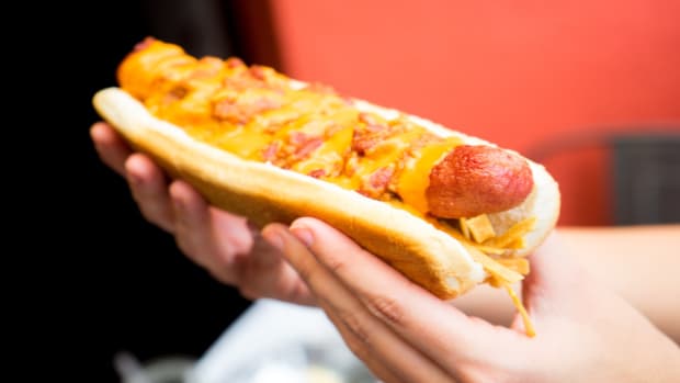 A woman holding a hot dog.