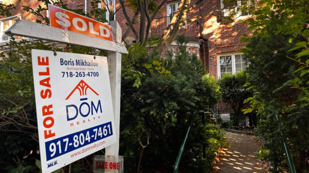 A "sold" sign in front of a home. lead.