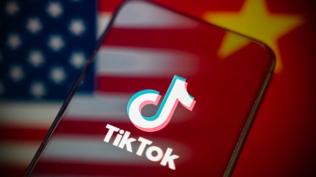 This photograph shows a smartphone screen displaying the logo of the Chinese app TikTok, reflecting the American and China flags, while the threat of a ban in the United States still looms with a deadline set for September 17, 2025, to comply with US requirements, in Creteil, France, on September 12, 2025. (Photo by Samuel Boivin/NurPhoto via Getty Images)