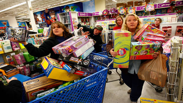 Shoppers wait in line while shopping at Toys"R"Us during the Black Friday sales event.