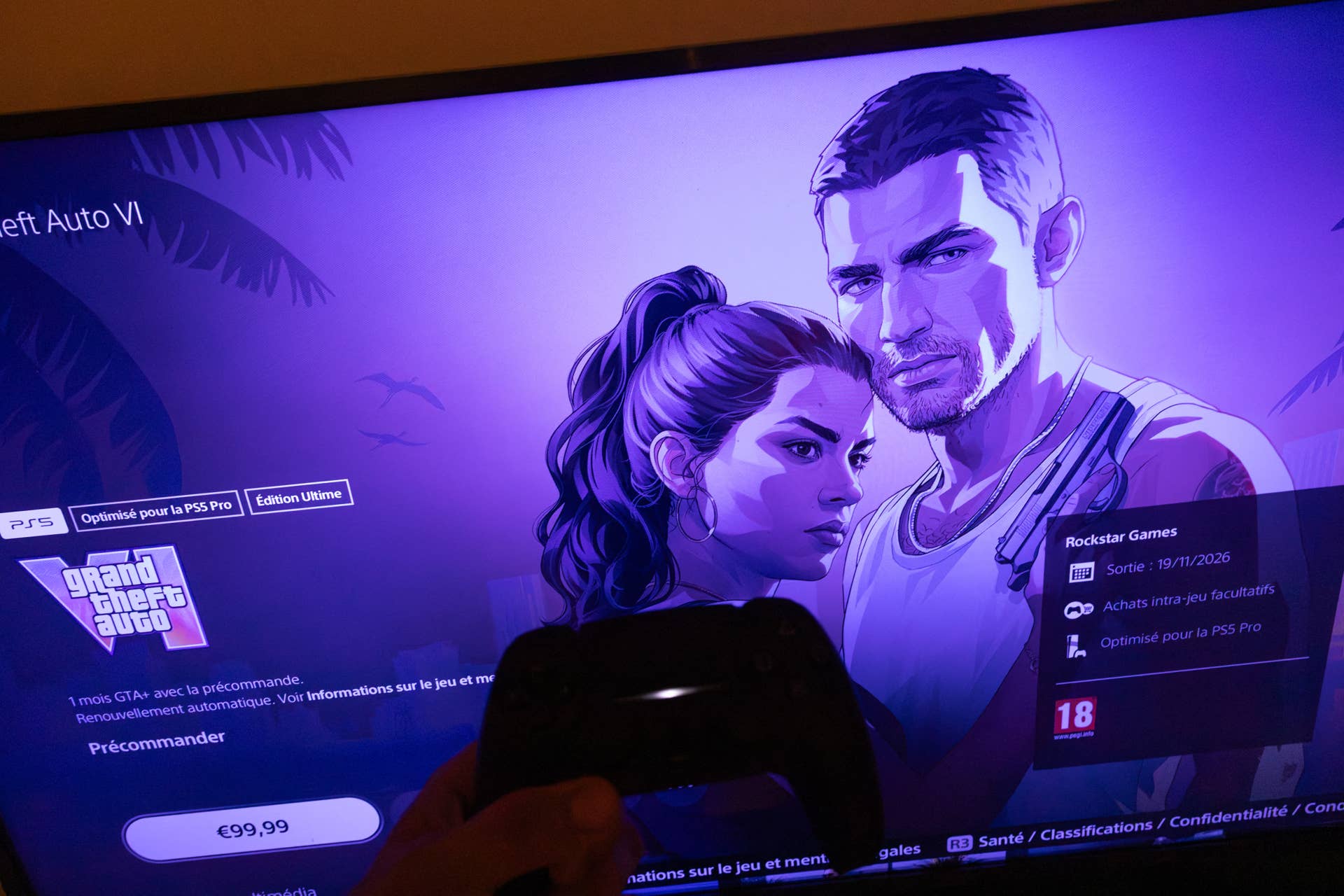 A PlayStation 5 controller is held in front of the Grand Theft Auto VI pre order page displayed on a television screen in Sartene South Corsica France on June 25, 2026.