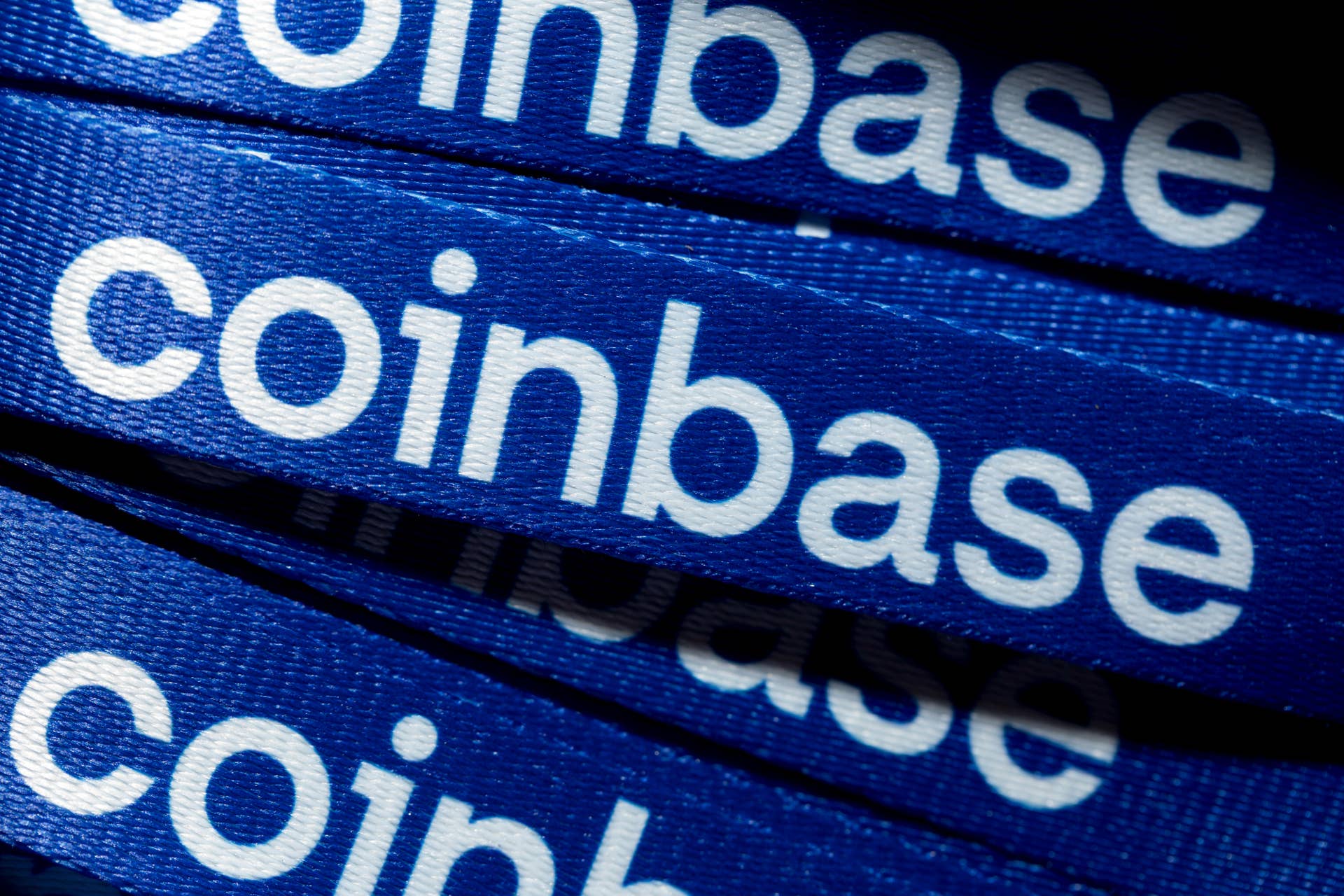 Coinbase branding on lanyards during the Australian Crypto Convention in Sydney, Australia, on Saturday, Nov. 22, 2025. 