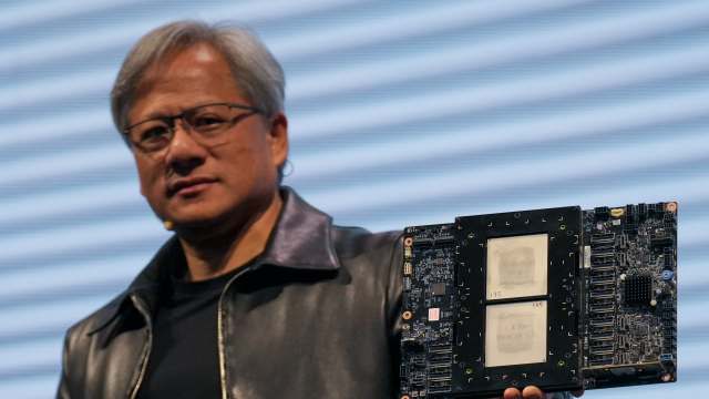 TAIPEI, TAIWAN - 2023/06/01: Jensen Huang, President of NVIDIA holding the Grace hopper superchip CPU used for generative AI at supermicro keynote presentation during the COMPUTEX 2023. The COMPUTEX 2023 runs from 30 May to 02 June 2023 and gathers over 1,000 exhibitors from 26 different countries with 3000 booths to display their latest products and to sign orders with foreign buyers. (Photo by Walid Berrazeg/SOPA Images/LightRocket via Getty Images)