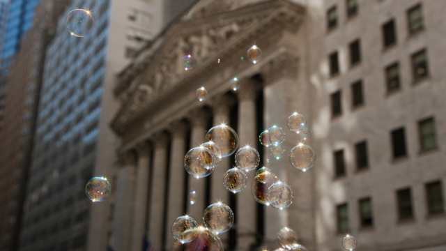 Soap Bubbles in front of the New York Stock Exchange symbolize the Danger of a new Bubble evolving in the Financial Markets