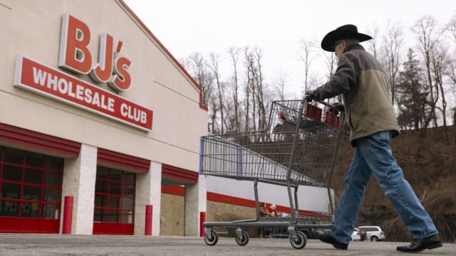 A shopper pushes a cart outside a BJ's Wholesale Club. Lead.