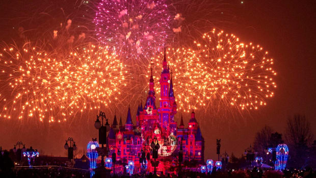 Disney castle at night with fireworks above