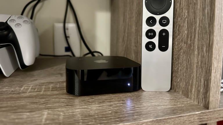 Apple TV 4k Wi fi and Ethernet box in man hand on the white