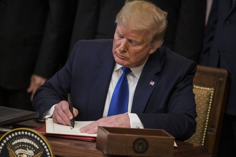 US President Donald Trump signed the deal at the White House. Photo: Bloomberg