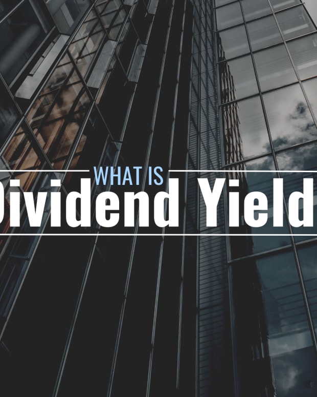 Darkened photo of a tall office building with stylized text overlay that reads "What Is Dividend Yield?"
