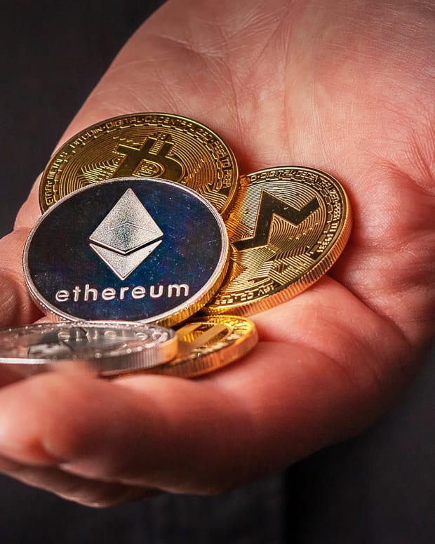 A man's hand holds Cryptocurrency Ethereum Lead