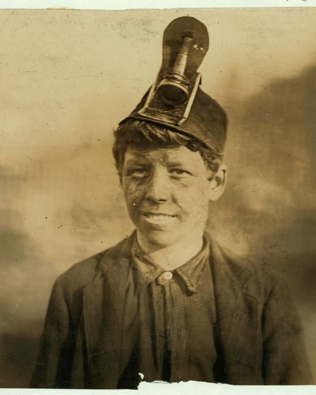 National Child Labor Committee. No. 191. Frank, a Miner Boy, going home. About 14 years old: has worked in the mine helping father pick and load for three years: was in hospital one year, when leg had been crushed by coal car.