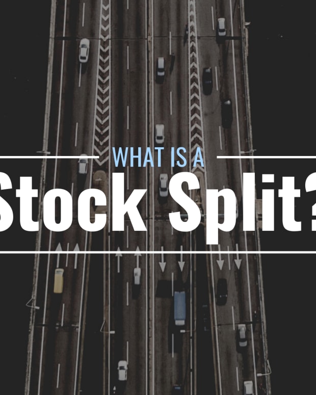 Darkened arial photo of a highway splitting into multiple sections with text overlay that reads "What Is a Stock Split?"