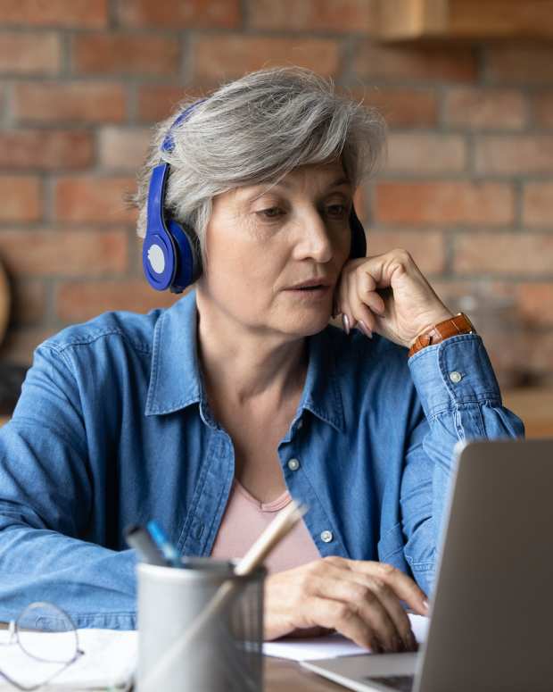 retired woman laptop listen sh