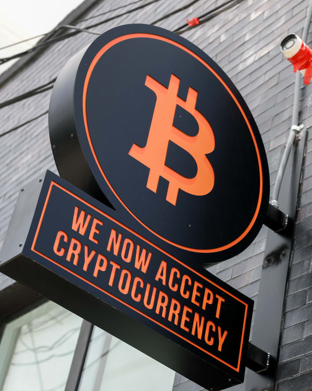 A Bitcoin sign is displayed on the wall of developers Ciprés and Rilea Group, who have sold a condominium unit in the Rider Residences, an under-construction project in Midtown Miami, using Bitcoin.
